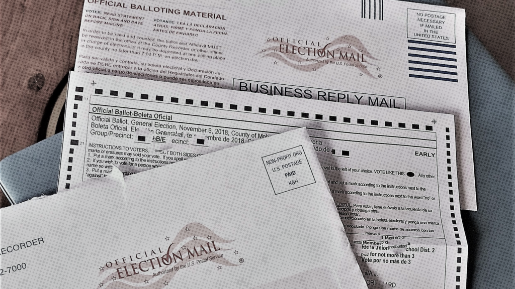 Election mailed envelope and ballot sitting on a table.